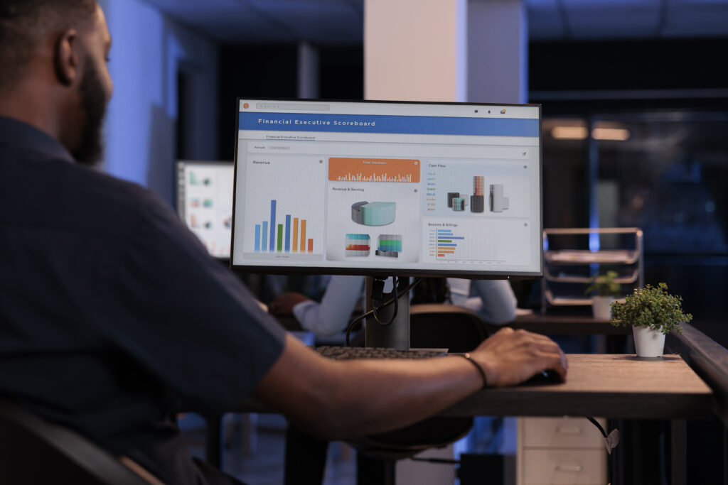 Executive manager looking at computer monitor with charts, analyzing statistics information and data to create project report, doing financial research. Pc screen with network presentation.
