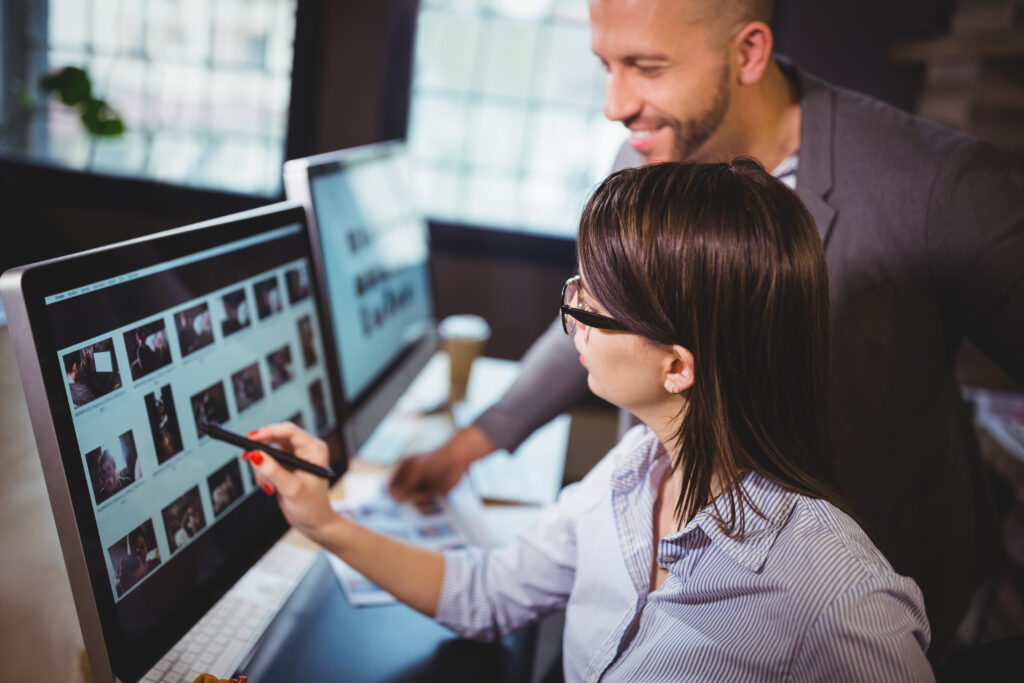 Happy man and woman working on a website